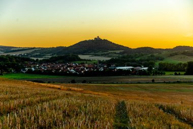 A fantastic sunset in the Thuringian Basin with a view of Wachsenburg Castle - Thuringia - Germany clipart