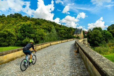 Travelling by bike on part of the Werratal Cycle Route stage from Hrschel near Eisenach to Eschwege - Thuringia - Germany clipart