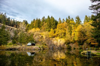 An autumn hike to the mountain lake at the Ebertswiese in the colourful Thuringian Forest - Thuringia - Germany clipart