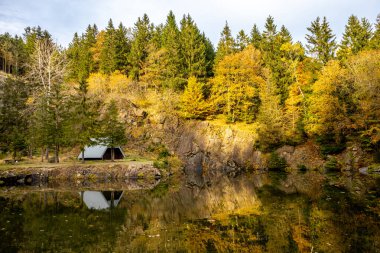 An autumn hike to the mountain lake at the Ebertswiese in the colourful Thuringian Forest - Thuringia - Germany clipart