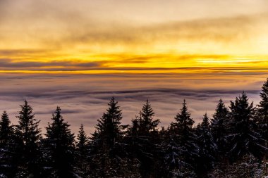 Romantic winter hike to the highest peak of the Rennsteig - the Schneekopf near Schmiedefeld in the evening light - Thuringia - Germany clipart