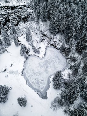 Winter hike through the snow-covered Thuringian Forest to the mountain lake at Ebertswiese near Floh-Seligenthal - Thuringia - Germany clipart