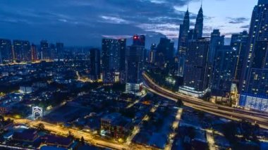 Modern Skyscraper and Traditional Housing Area at Kuala Lumpur, Malaysia during sunrise