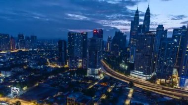 Modern Skyscraper and Traditional Housing Area at Kuala Lumpur, Malaysia during sunrise