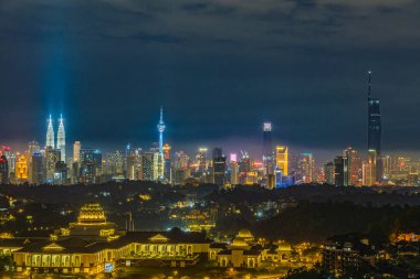 Cityscape of Kuala Lumpur, Malaysia at night with blue sky