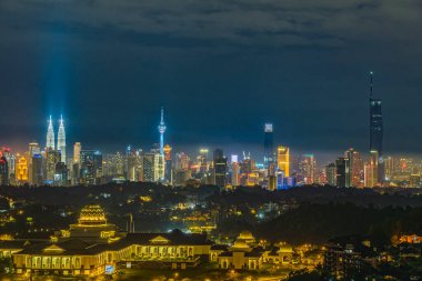 Cityscape of Kuala Lumpur, Malaysia at night with blue sky