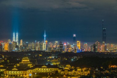 Cityscape of Kuala Lumpur, Malaysia at night with blue sky
