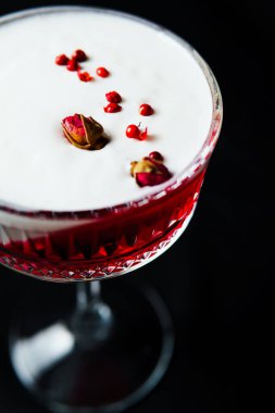 Alcoholic drink. A cocktail with elite alcohol on dark black background, close-up. Concept of  nightlife and exotic drinks.