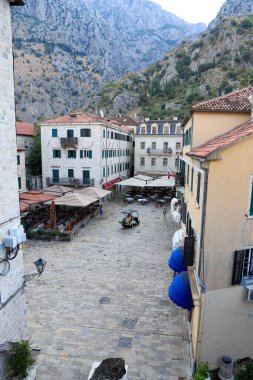 Kotor's narrow cobblestone streets and historic stone houses, a UNESCO World Heritage site. Old town architecture details. Old town square clipart