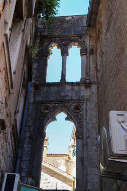 Kotor's narrow cobblestone streets and historic stone houses, a UNESCO World Heritage site. Old town architecture details. Vertical format clipart