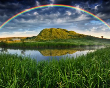 Landscape with a Rainbow on the River in Spring. colorful morning. nature of Ukraine
