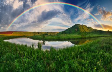 Landscape with a Rainbow on the River in Spring. colorful morning. nature of Ukraine