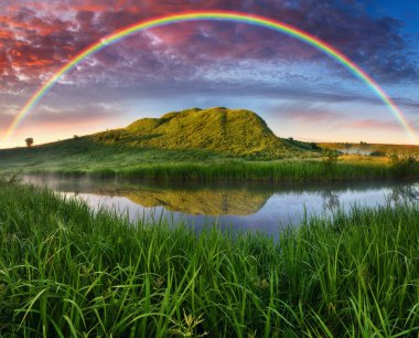 Landscape with a Rainbow on the River in Spring. colorful morning. nature of Ukraine