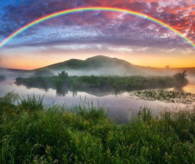 Landscape with a Rainbow on the River in Spring. colorful morning. nature of Ukraine