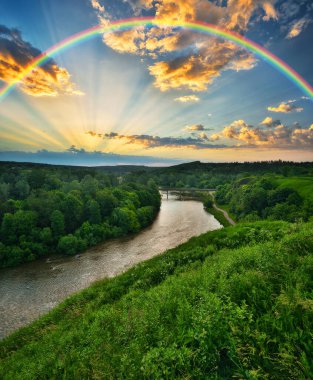 Landscape with a Rainbow on the River in Spring. colorful morning. nature of Ukraine