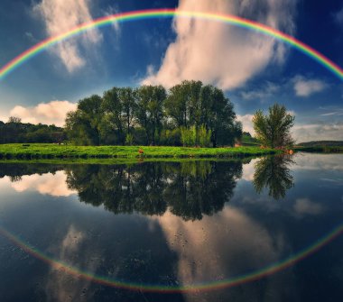 Landscape with a Rainbow on the River in Spring. colorful morning. nature of Ukraine