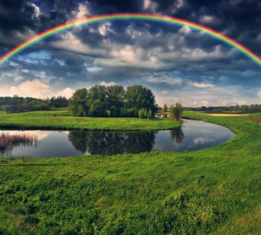 Landscape with a Rainbow on the River in Spring. colorful morning. nature of Ukraine