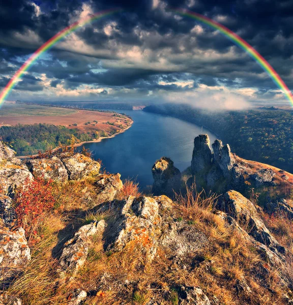 colorful rainbow over river canyon. autumn landscape. nature of Ukraine