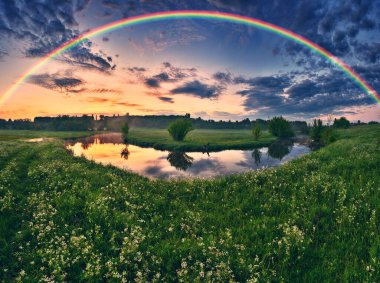 Landscape with a Rainbow on the River in Spring. colorful morning. nature of Ukraine