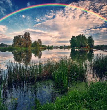 Landscape with a Rainbow on the River in Spring. colorful morning. nature of Ukraine