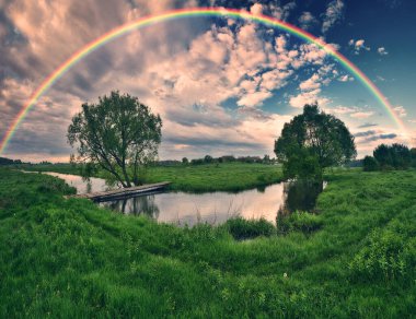 Landscape with a Rainbow on the River in Spring. colorful morning. nature of Ukraine