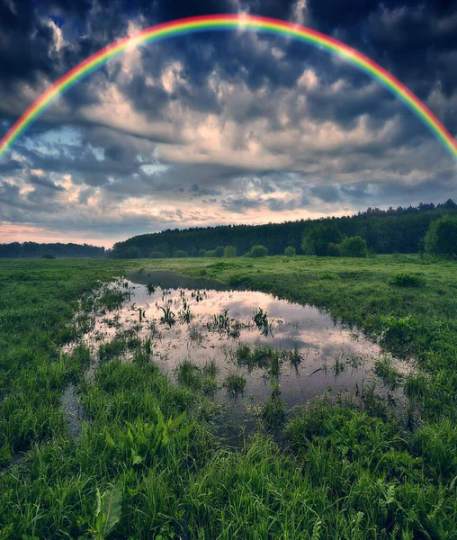 Landscape with a Rainbow on the River in Spring. colorful morning. nature of Ukraine