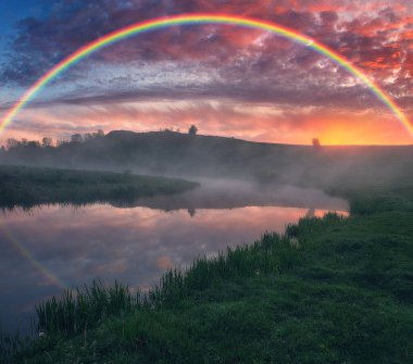 Landscape with a Rainbow on the River in Spring. colorful morning. nature of Ukraine