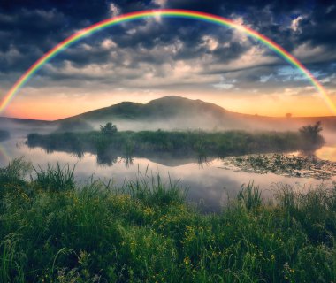Landscape with a Rainbow on the River in Spring. colorful morning. nature of Ukraine