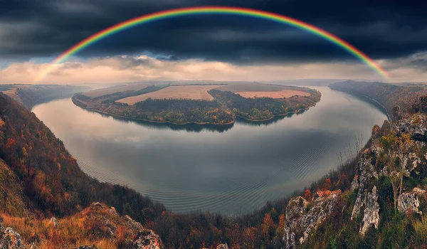 colorful rainbow over river canyon. autumn landscape. nature of Ukraine