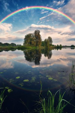 Landscape with a Rainbow on the River in Spring. colorful morning. nature of Ukraine