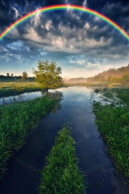 Landscape with a Rainbow on the River in Spring. colorful morning. nature of Ukraine