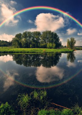 Landscape with a Rainbow on the River in Spring. colorful morning. nature of Ukraine