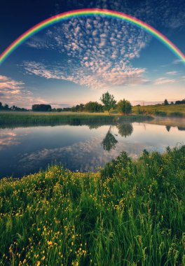 Landscape with a Rainbow on the River in Spring. colorful morning. nature of Ukraine