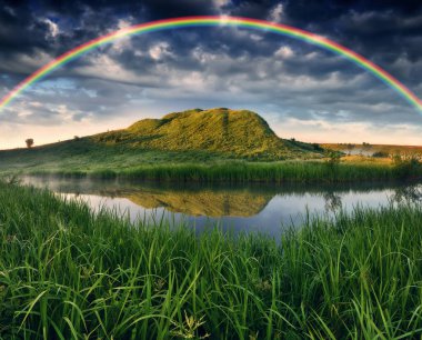 Landscape with a Rainbow on the River in Spring. colorful morning. nature of Ukraine