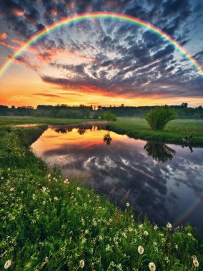 Landscape with a Rainbow on the River in Spring. colorful morning. nature of Ukraine