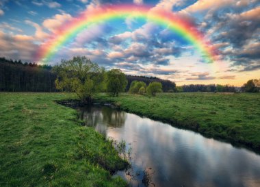 Landscape with a Rainbow on the River in Spring. colorful morning. nature of Ukraine