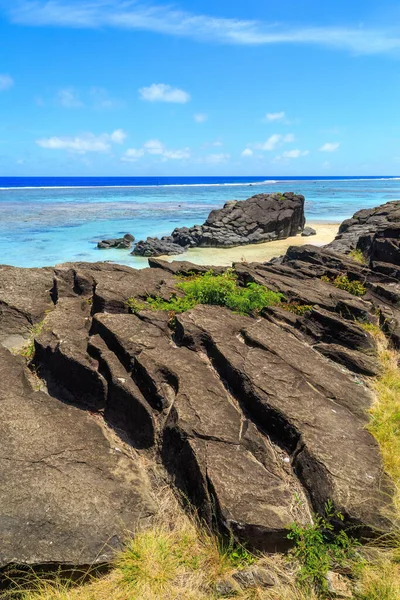The Black Rock, a distinctive formation of volcanic basalt just off the coast of Rarotonga in the Cook Islands