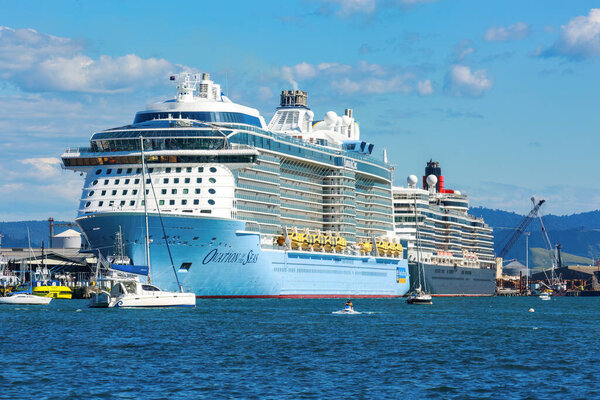 The giant cruise ship "Ovation of the Seas" in port at Mount Maunganui, New Zealand, with the smaller "Queen Elizabeth" behind. December 30 2022