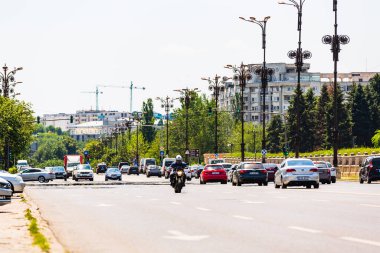Biker on a motorcycle in traffic at rush hour in downtown area of the city in Bucharest, Romania, 2022