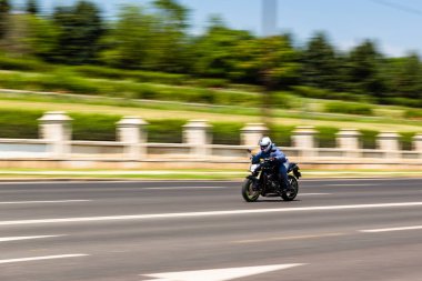 Biker on a motorcycle in traffic at rush hour in downtown area of the city in Bucharest, Romania, 2022