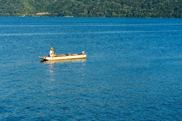 stock image Man in boat relaxing and fishing on Danube river on a sunny day in Orsova, Romania, 2020.