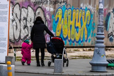 2022 Bükreş, Romanya 'da çocuklu bekar bir anne bebek arabasıyla geziyor.