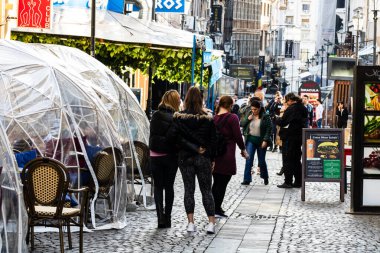 People and tourists wander the streets of the Bucharest Old Town, Romania, 2022