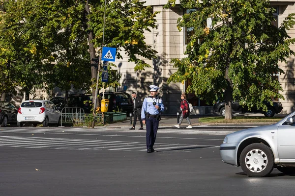 stock image Police agent, Romanian Traffic Police (Politia Rutiera) directing traffic. Rush hour in Bucharest, Romania, 2022