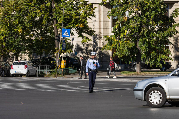 Police agent, Romanian Traffic Police (Politia Rutiera) directing traffic. Rush hour in Bucharest, Romania, 2022