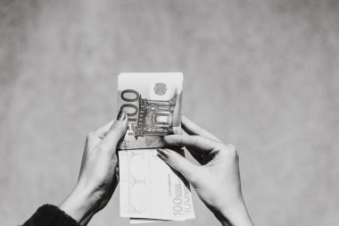 Avro parasını tutmak ve göstermek ya da para vermek. Dünya para kavramı, 100 avro banknot fotokopi alanı ile izole edilmiş para birimi. Zengin iş adamları kavramı, para biriktirmek ya da harcamak.