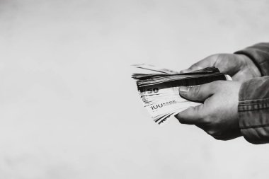 Man hand giving money like a bribe or tips. Holding EURO banknotes on a blurred background, EURO currency