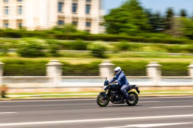 Biker on a motorcycle in traffic at rush hour in downtown area of the city in Bucharest, Romania, 2022