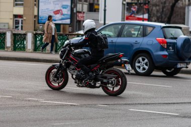Motorcyclist on motorbike in traffic in Bucharest, Romania, 2022