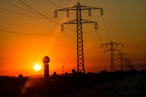 Electric power pylon, electric tower at sunset